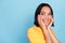 Portrait of positive curious nice girl with bob hairstyle wear yellow t-shirt look empty space shy isolated on blue