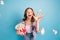 Portrait of positive excited school girl hand throwing popcorn toothy smile look camera isolated on blue color