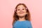 Portrait of positive genius child, clever little girl wearing pink glasses and looking at camera with smart happy expression