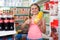 Portrait of positive girl doing grocery shopping