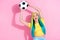 Portrait of positive good mood girl football fan goalkeeper catch ball vivid teal hair isolated on pink color background