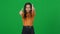 Portrait of positive joyful teen African American girl showing thumbs up looking at camera on green screen. Happy