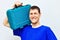 Portrait of a positive locksmith wide smile. A worker holds a tool case on his shoulder.