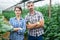 Portrait of positive married couple in greenhouse