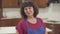 Portrait of a positive mature Caucasian woman with brown eyes and curly hair looking at the camera and smiling. Happy