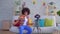 Portrait positive smiles young African American woman with Afro hairstyle blogger writes video in the living room slow