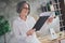 Portrait of positive successful lawyer lady hold read clipboard annual report document workstation indoors