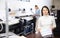 Portrait of positive woman printing office worker with colour schedule