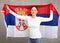 Portrait of positive young woman with flag of Serbia