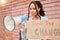 Portrait, poster and woman on megaphone for change, protest or human rights on brick wall background. Billboard, speaker