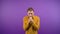 portrait of praying hopeful man on isolated purple background 4K