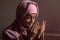 Portrait of praying Muslim woman