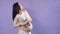 Portrait of a pregnant woman holding baby small shoes near her big tummy.