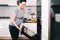 Portrait of pregnant woman preparing pizza at home