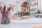 portrait of preschooler drawing picture with pencils at table