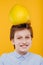 Portrait preteen child boy with pomelo fruit On the head