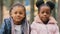 Portrait preteen cute children close-up two sisters spend time in city park little friends looking at camera happily