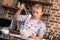 portrait of preteen girl in apron with whisk cooking alone