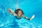 Portrait of preteen girl diving with fun in pool