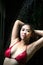 Portrait of pretty Asian woman wearing red bikini pose on shower for washing at swimming pool.