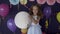 Portrait of pretty baby girl holding big white balloon concept of birthday party