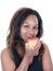 Portrait of pretty black woman eating taking bite of red apple