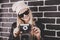Portrait of pretty blond hair smileing young teenage hipster woman model with retro photo camera wearing a pink hat