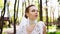 Portrait of pretty bride with makeup and crystals on face walking in sunlit park