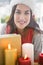 Portrait of pretty brunette behind candles