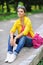 Portrait of pretty cheerful young girl in a park