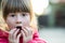 Portrait of a pretty child girl making amazed shoked expression on her face outdoors