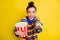 Portrait of pretty cute brunette girl eating pop corn hold remote controller wear rainbow sweater isolated on bright