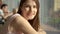 Portrait of pretty dreamy young woman sitting at table in cafe near window thinking looking at camera smiling. Food