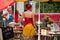 Portrait of pretty florist with orange dress at the market on back view