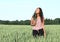 Portrait of pretty girl in field with wheat