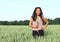 Portrait of pretty girl in field with wheat