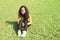 Portrait of pretty girl sitting on grass