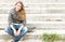 Portrait of pretty girl with skateboard outdoor.