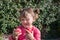 Portrait of a pretty little girl crunching freshly picked apples