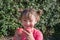 Portrait of a pretty little girl crunching freshly picked apples