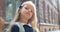 Portrait of pretty little girl looking to camera. Close up of adorable kid with long blond hair posing while standing at