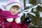 Portrait of pretty little girl in winter clothes near snow cover