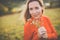 Portrait of a pretty middle-aged  woman outside in a park, picking flowers