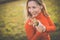 Portrait of a pretty middle-aged  woman outside in a park, picking flowers