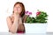 Portrait of pretty middle-aged woman with pelargoniums in a flow