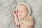 Portrait of pretty newborn. Cute baby sleeping and smiling