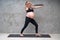 Portrait of pretty pregnant woman exercises with resistance band in the gym