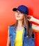 Portrait of pretty stylish young girl wearing a cap and jeans