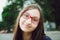 Portrait of a pretty teen girl with glasses. Natural posing on the street