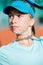 Portrait of a pretty teenage girl in a tennis cap with a net shadow on her face